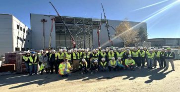 Group photo of the student visit in front of the hangar at Brnik