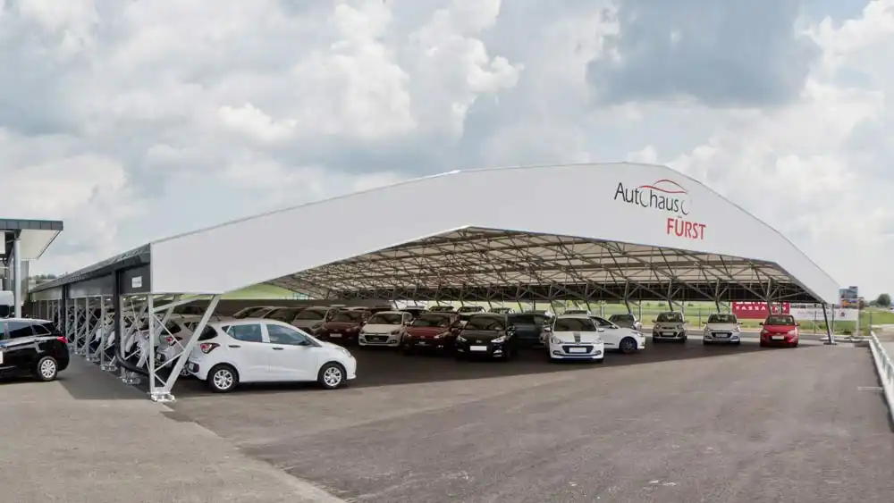 Covered car park with a steel structure protects vehicles for sale